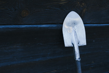 Old rusty shovel prop up against Old wooden wall, Wooden texture background