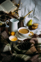 Cozy home weekend arrangement, warm bedroom decorations with coffee, wool blanket