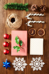 Christmas elements and decoration flat lay on a wooden background viewed from above. Top view