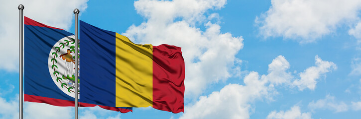 Fototapeta premium Belize and Romania flag waving in the wind against white cloudy blue sky together. Diplomacy concept, international relations.