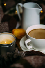 Cozy home weekend arrangement, warm bedroom decorations with coffee, wool blanket