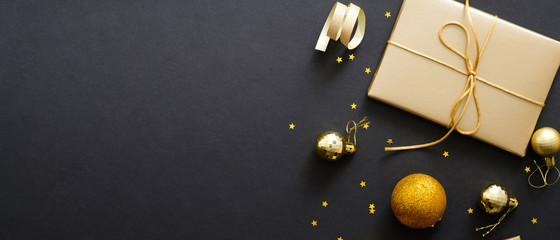 christmas banner with golden balls and gift boxes on black background