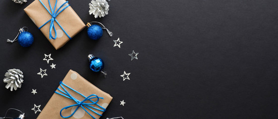 Black Christmas background with blue balls and snowflakes