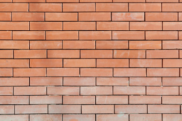 fragment of dirty red brick wall