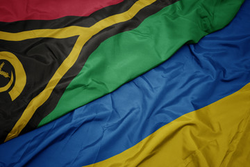 waving colorful flag of ukraine and national flag of Vanuatu .