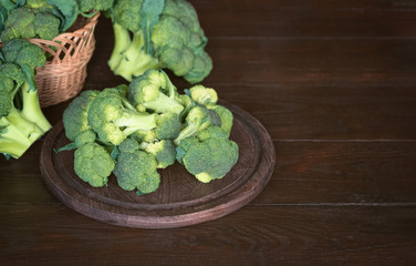fresh green broccoli. broccoli blossoms on a cutting Board on the table close-up. fresh broccoli in a basket on a wooden background.