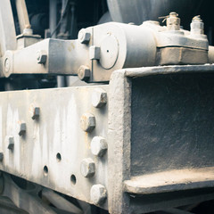 Abstract industrial background featuring detail of old steam locomotive frame. Steel painted background  illustrating vintage industry and construction concepts.