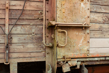 Closeup of old weathered wooden door with latch of European railway cargo carriage  also served as deportation carriage exposed in Budapest, Hungary.