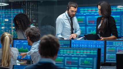 Multi-Ethnic Team of Traders is Busy Working at the Stock Exchange Office. Dealers and Brokers Buy...