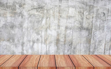 The view of the brown wooden floor with the backdrop of the cement wall.