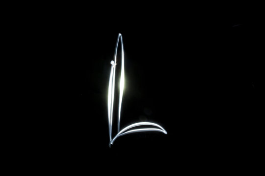 Detail of a L letter drawn with light and the technique of long exposure