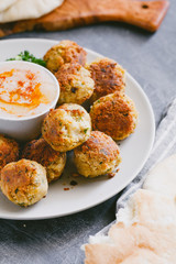 Famous traditional Middle Eastern dish falafel with hummus on a served plate.