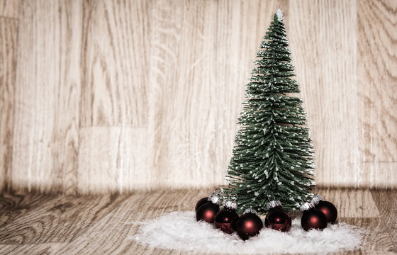 Imagen de Navidad, árbol de Navidad rodeado de bolas rojas con un fondo de madera
