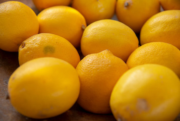 Lemon background.Selective focus. yellow fruits are stacked side by side.