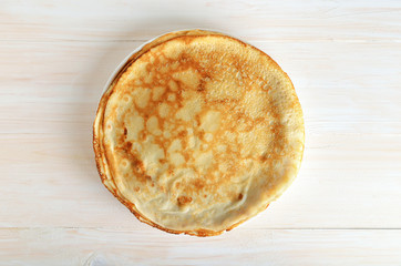 Stack of pancakes on a white wooden surface