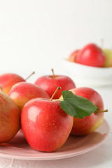 Plate with apples on white background, close up