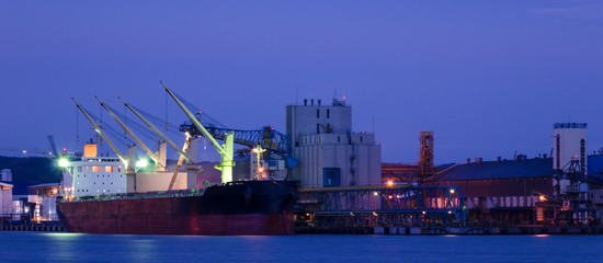 EVENING HARBOR LIFE - Illuminated ship at the grain terminal in Gdynia