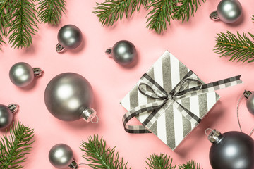 Christmas flat lay background on pink with present box and decorations.
