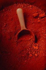 crimson pigment powder with spoon