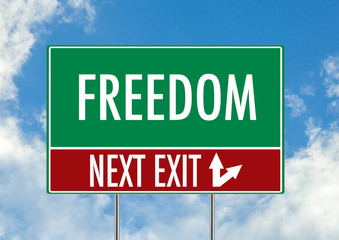 Next exit for freedom green road sign over blue sky background. Concept road sign collection.
