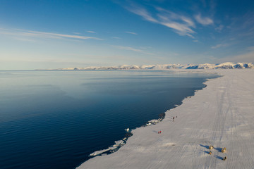 Obraz premium Aerial drone photo of tourists visit the floe edge near Sirmilik National Park in Nunavut, Canadaa