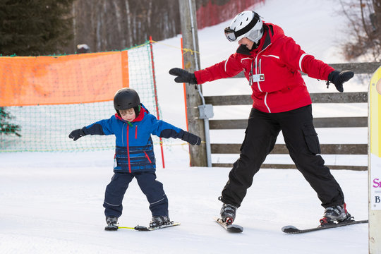 Young boy takes a skiing lesson