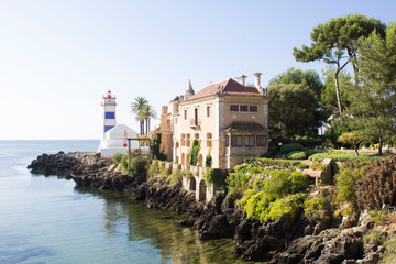 Beautiful view of the beach, lighthouse and villa on the sunny day. Cascais. Portugal. - obrazy, fototapety, plakaty