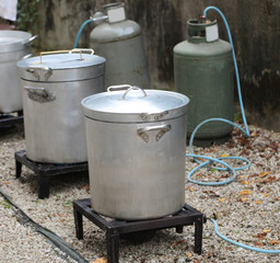 outdoor kitchen with many big cauldrons without people