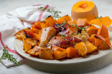 Fried chicken legs with pumpkin and orange.