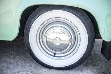 Whitewall tire mounted on restored 60s car