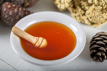 Pine tree , natural pine honey in bowl on wooden background.