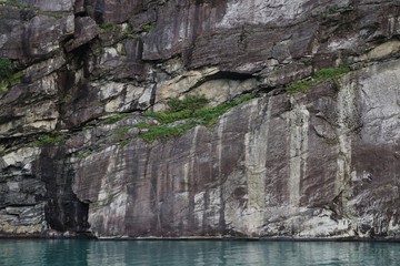 Views of the rocky and waterfall lined shores along the fjords of Norway