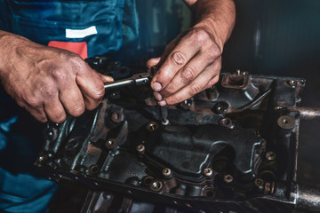 The auto mechanic deconstructs the internal combustion engine. Repair service.