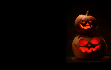 Two Halloween pumpkin with scary face. Jack-o-lantern in the dark