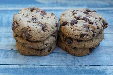 A stack of chocolate cookies on a wooden board