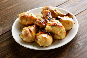 Fried chicken drumsticks on white plate