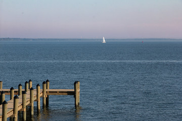 Fototapeta na wymiar Boat and old dock at Chesapeake Bay