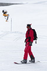 Snowboarder in red on snowy ski slope