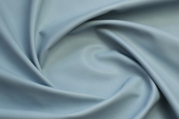 blue artificial leather with waves and folds on PVC base