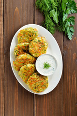 Diet vegetable cutlet from  zucchini, carrot, herbs on wooden table