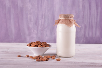 Bottle of almond milk on the wooden table	