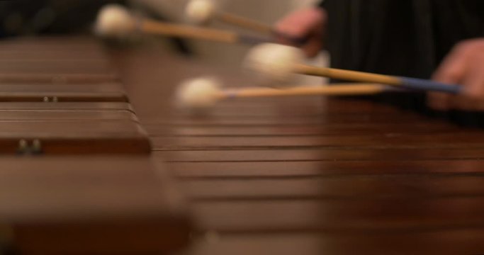 Close up shot of musician hands playing xylophone