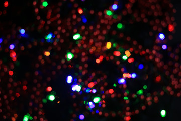 Naklejka na ściany i meble Abstract blurred colorful background with flickering light bulbs. Holiday concept. New Year's and Christmas