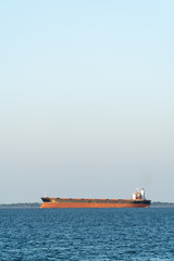Ships carrying soybeans produced in Brazil for export sailing on the Tapajos River, in sunny days, in the Amazon. Santar&eacute;m, Para. Transport, commerce, environment, agriculture and economy concept.