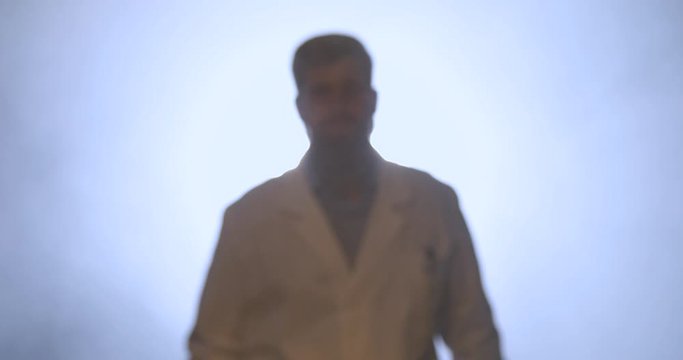 Medico con barba lunga che cammina di fronte la telecamera