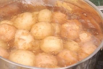 New potatoes boil in their skins in a saucepan