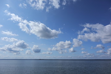 Beautiful Belarus skyscape on big lake in national park with sparkling water and marvelous clouds in blue sky landscape background