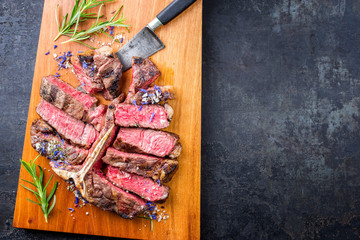 Traditional barbecue dry aged wagyu porterhouse steak sliced with herb and spice offered as top...