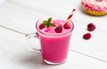Raspberry smoothie and a pink doughnut