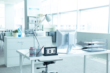 Interior of a modern office with computer and white furniture